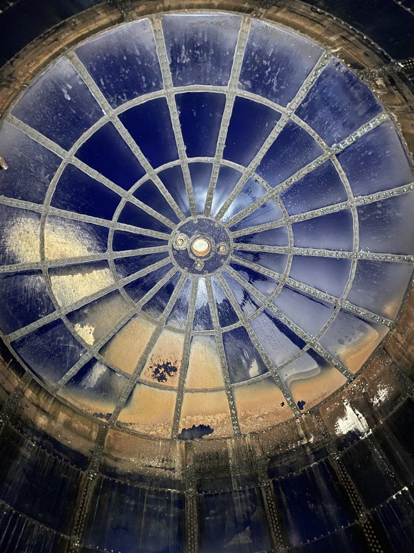 Interior of an aging glass-lined steel tank showing coating distress