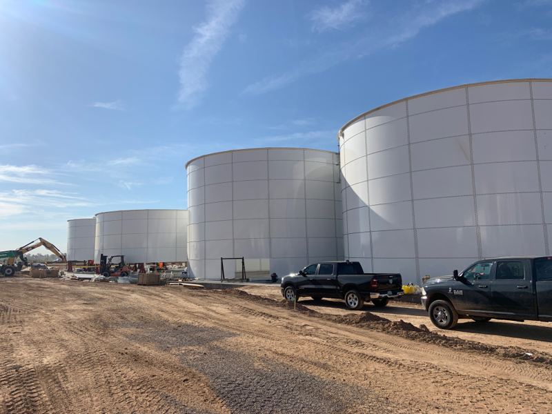 Tank farm of four bolted steel tanks for wastewater storage at a jobsite