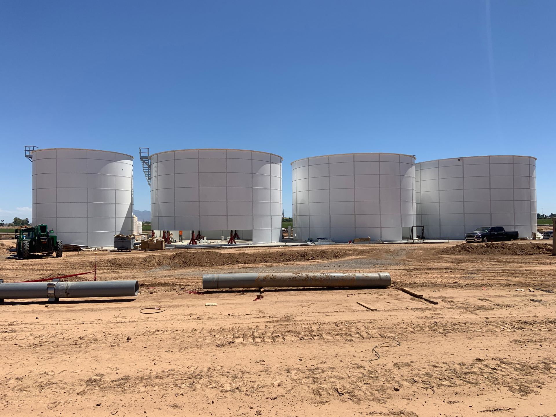 Four bolted steel storage tanks installed at a jobsite
