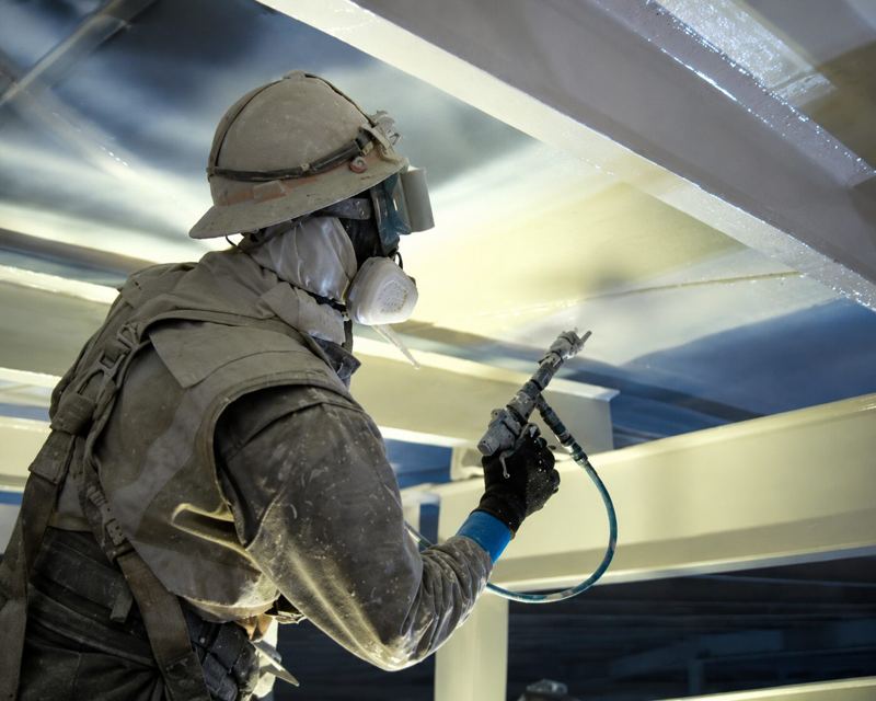 Protective coating being spray-applied to a steel tank