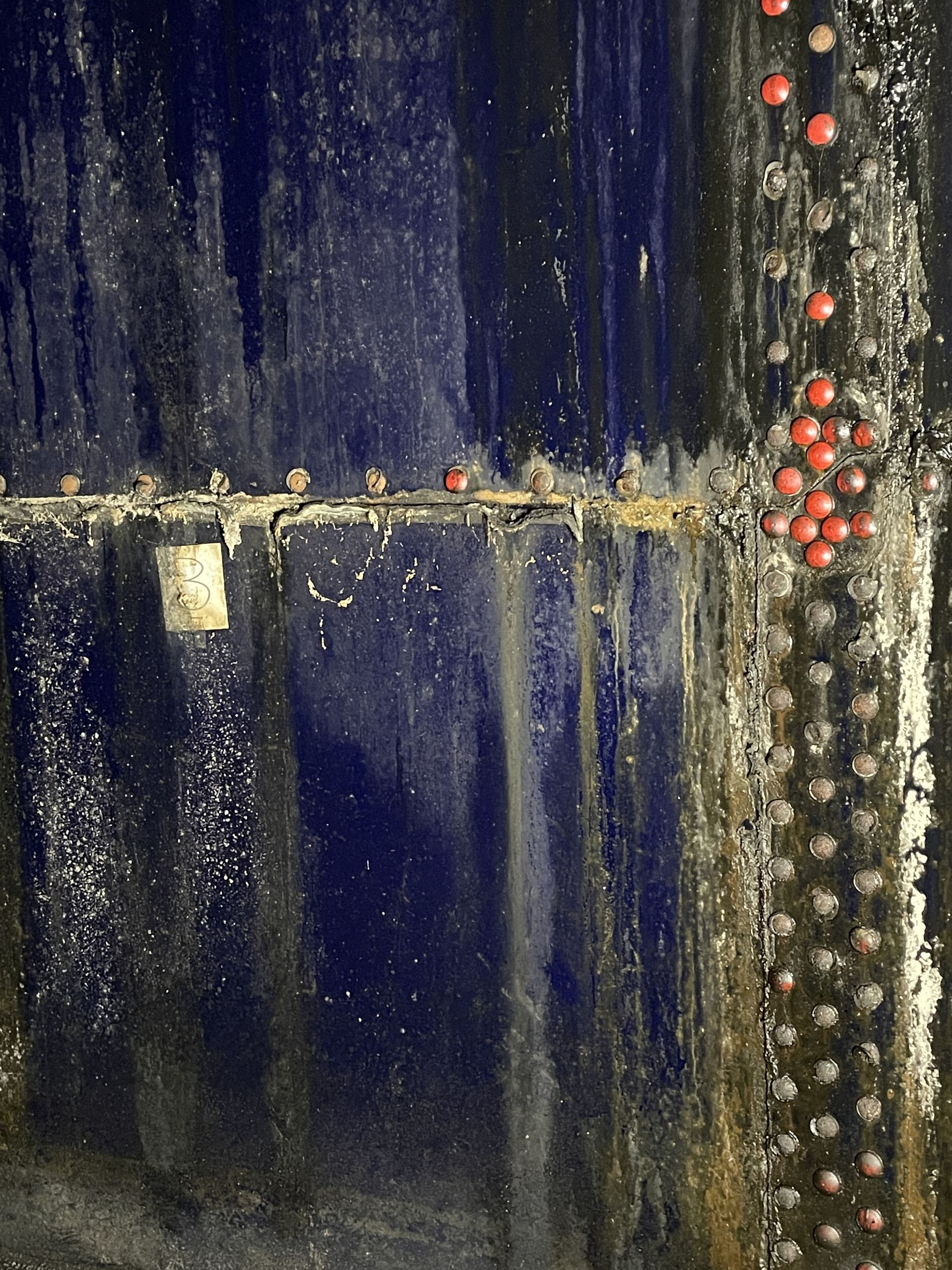 Forensic view of advanced corrosion on the interior steel wall of a storage tank