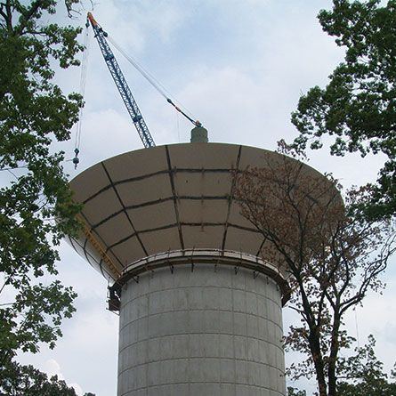 Welded steel composite elevated water tank (CET) under construction with a crane