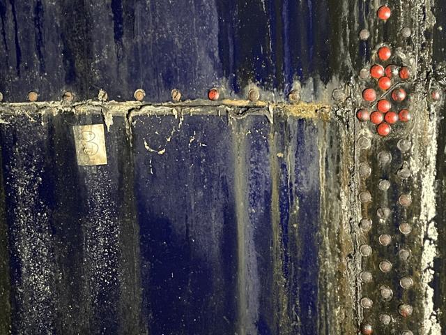 Corrosion along interior bolted seams of a drained tank