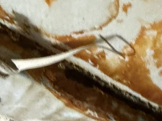 Lining disbonded from the floor near the outlet sump, with corrosion beneath