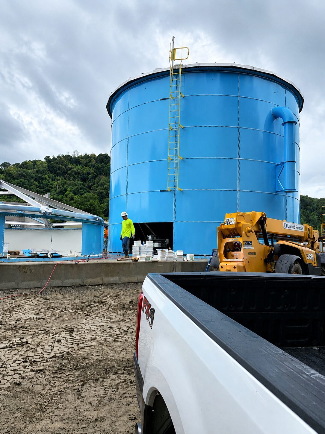 Low-profile bolted steel tank on a prepared construction site