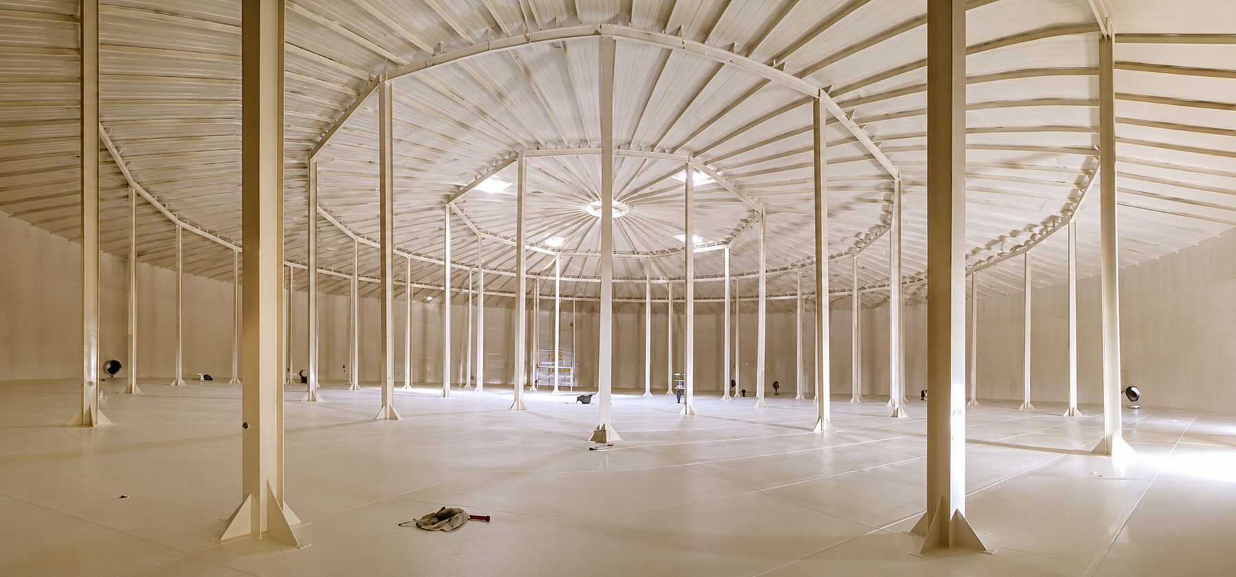 Bright finished tank interior with a clean protective lining on the floor, walls, roof, and columns