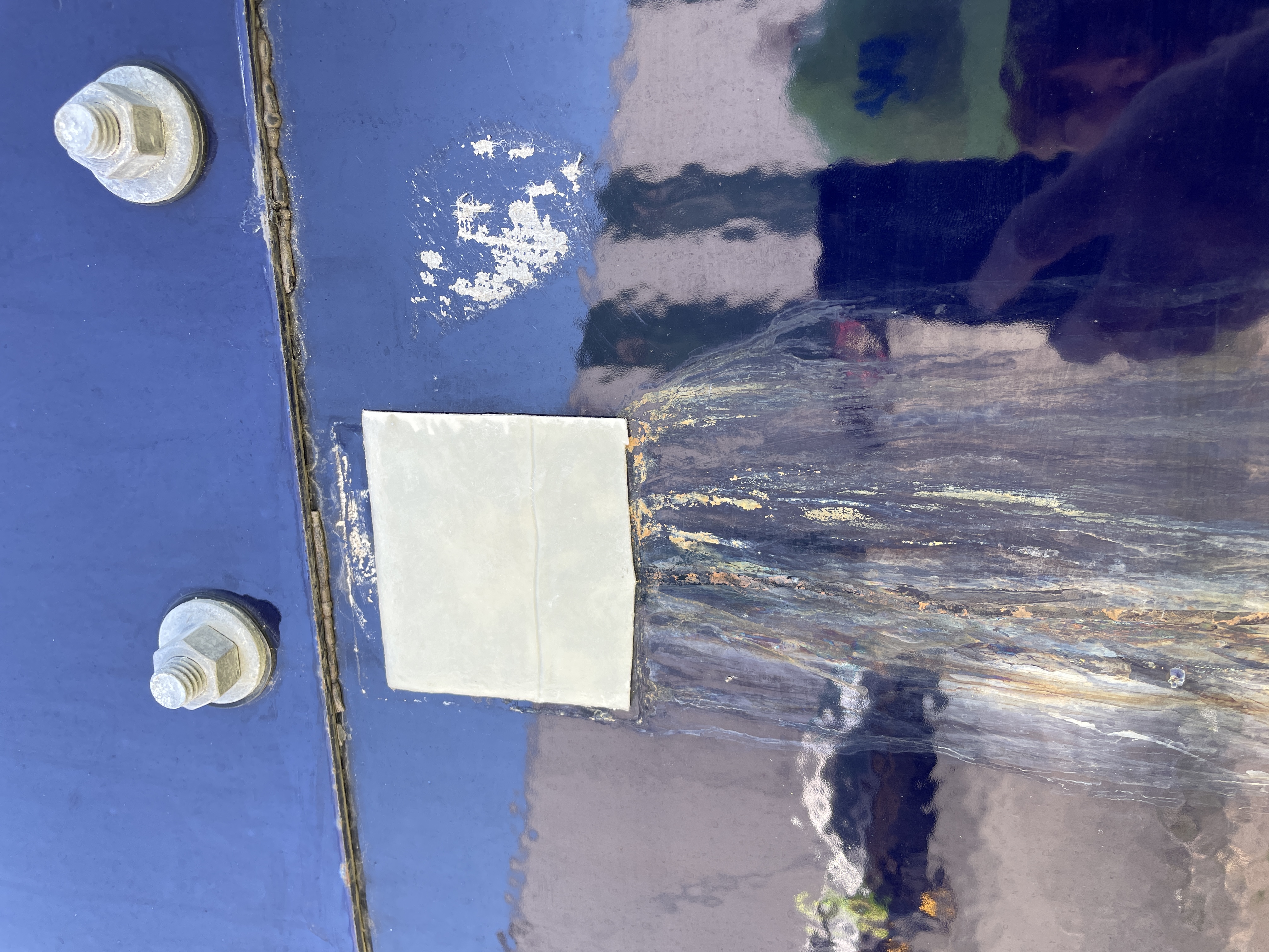 Tank seam with a patch repair and undercutting corrosion along the joint