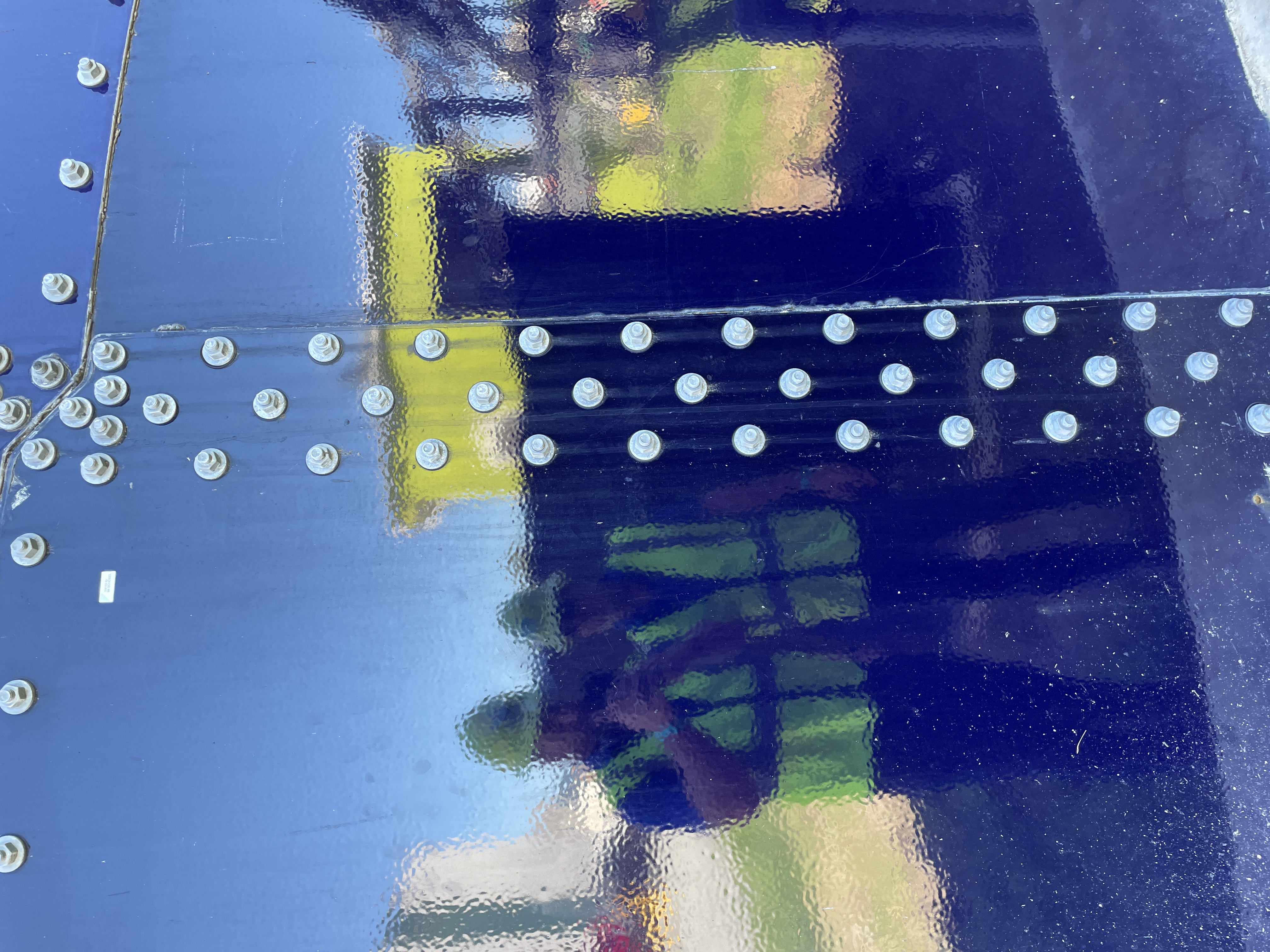 Bolt pattern across a coated bolted tank floor panel