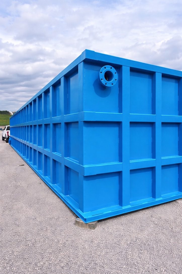 Completed modular bolted steel storage tank set on a prepared site